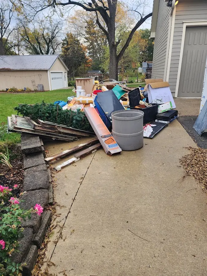 Dumpster being loaded with debris for 12 Yard Dumpster Rental in Lawnside